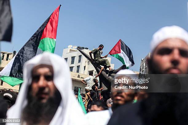 Palestinian supporters of Hamas and Islamic Jehad hold national flags shouting slogans during a protest against Palestinian-Israeli negotiations on...