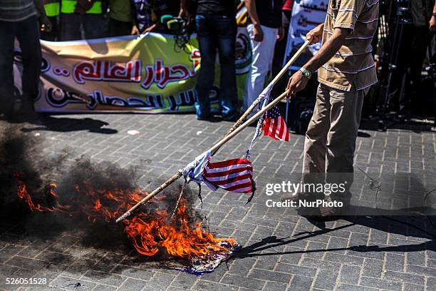 Palestinian supporters of Hamas and Islamic Jehad hold national flags shouting slogans during a protest against Palestinian-Israeli negotiations on...