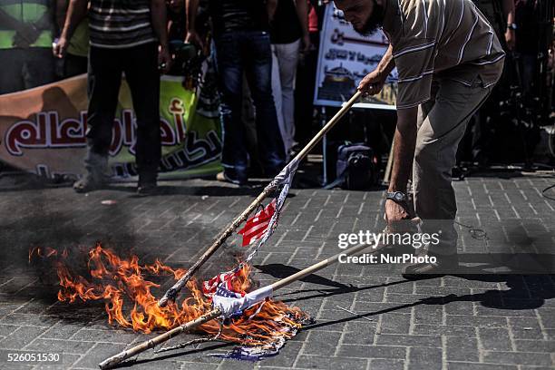 Palestinian supporters of Hamas and Islamic Jehad hold national flags shouting slogans during a protest against Palestinian-Israeli negotiations on...