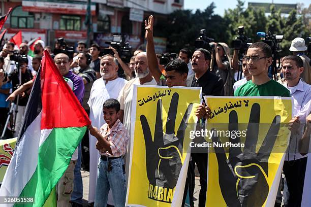 Palestinian supporters of Hamas and Islamic Jehad hold national flags shouting slogans during a protest against Palestinian-Israeli negotiations on...