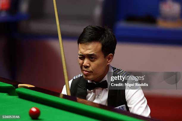 Marco Fu of Hong Kong in action during his semi final match against Mark Selby of England on day fourteen of the World Championship Snooker at...