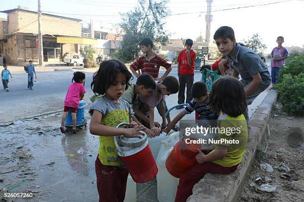 Eastern Ghouta, Syria, on july 13, 2015. Children fill their jerry from the well and waiting for their turn to come due to congestion The suffering...