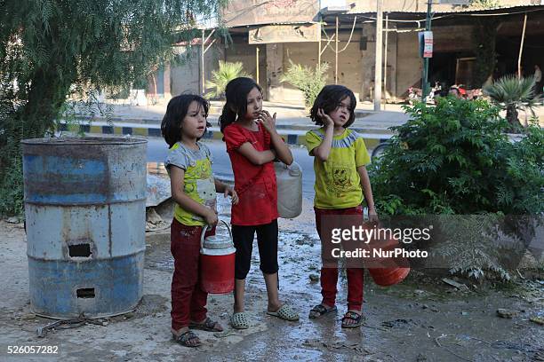 Eastern Ghouta, Syria, on july 13, 2015. Children fill their jerry from the well and waiting for their turn to come due to congestion The suffering...