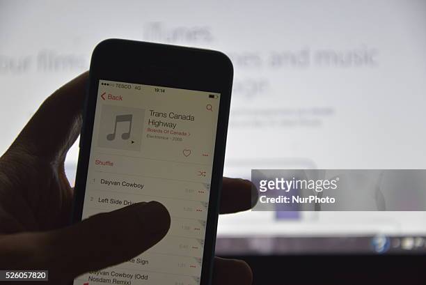 Person browsing their music collection stored on an iPhone 5c on Monday 20th July 2015.