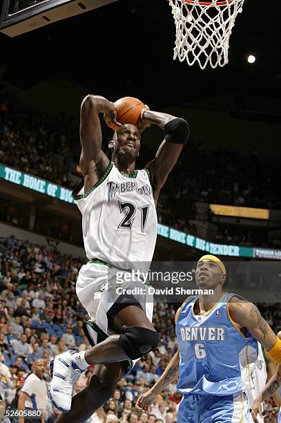 Kevin Garnett of the Minnesota Timberwolves goes up for the slam dunk over Kenyon Martin of the Denver Nuggets on April 8, 2005 at the Target Center...