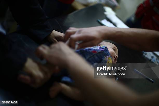 Nurse gives an Hepatitis A vaccines, to a child in the vaccine's center belongs to the Syrian Arab Red Crescent - Douma branch, Picture is taken in...