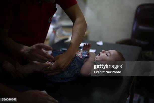 Nurse gives an Hepatitis A vaccines, to a child in the vaccine's center belongs to the Syrian Arab Red Crescent - Douma branch, Picture is taken in...