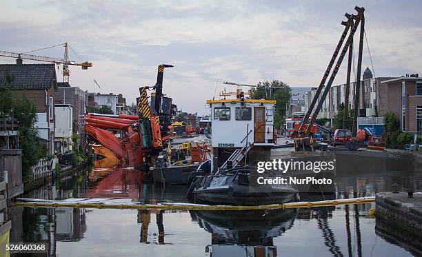 Aug. 6, 2015 - Two large cranes carrying a part of a bridge weighing 190 tons slid of a pontoon and crashed into several houses along the canal. The...