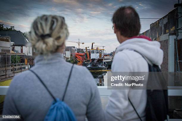 Aug. 6, 2015 - Two large cranes carrying a part of a bridge weighing 190 tons slid of a pontoon and crashed into several houses along the canal. The...