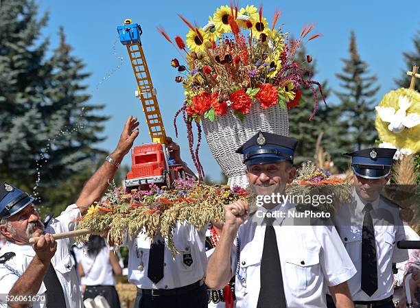 Hundreds of people dressed in traditional folk costumes with wreaths from their Parishes during the wreaths presentation at the 2015 edition of the...