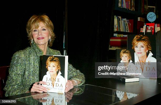 Actress Jane Fonda poses with her new memoir "My Life so Far" which she signed for fans at a Book Soup on April 7, 2005 in West Hollywood, California.