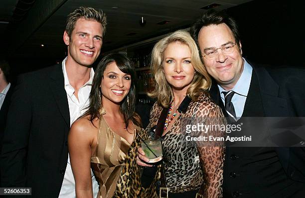 Actor Ryan McPartlin and wife Danielle pose with actor Dan Aykroyd and wife Donna Dixon at a party for the premiere the new TV series "Living With...