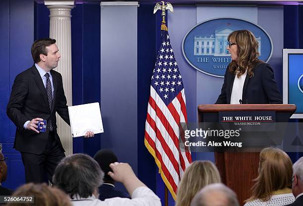 White House press secretary Josh Earnest comes in with a mock surprise as actress Allison Janney speaks as she shows up to surprise members of the...