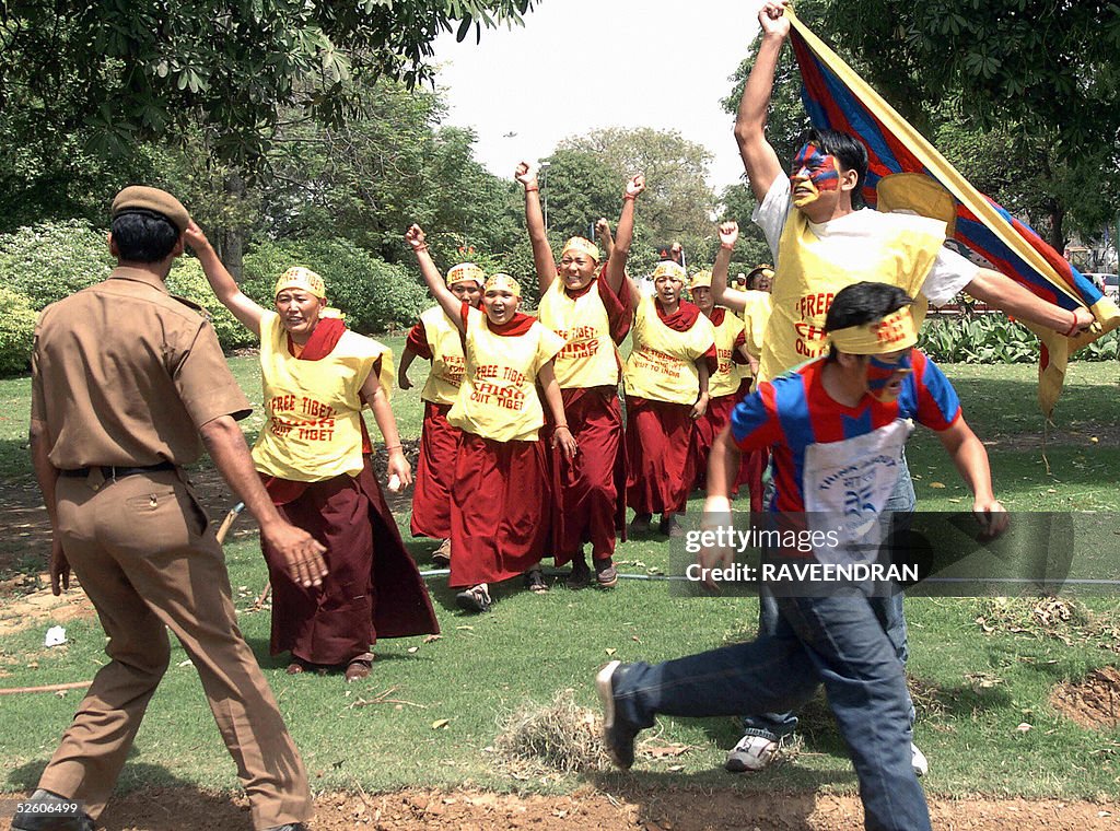 Tibetan protesters run through the Chine