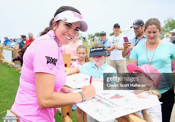 Gerina Piller poses as she signs an autograph for a fan after finishing with a six-under par 65 during the second round of the Volunteers of America...