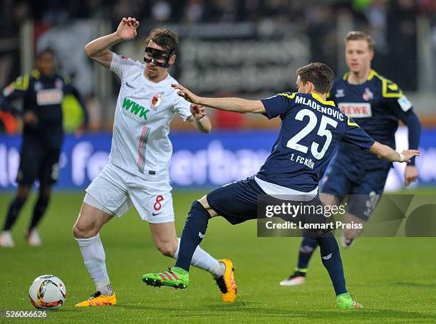 Markus Feulner of FC Augsburg challenges Filip Mladenovic of 1. FC Koeln during the Bundesliga match between FC Augsburg and 1. FC Koeln at WWK Arena...