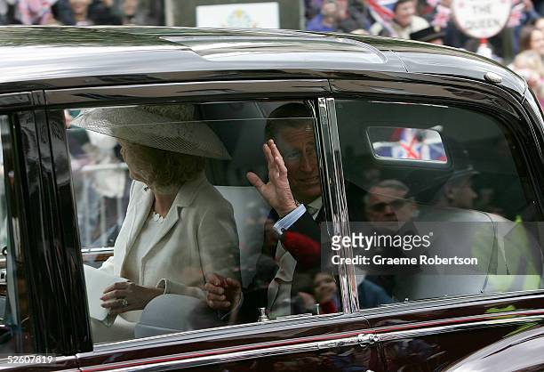 Prince Charles, the Prince of Wales, and his wife Camilla, the Duchess of Cornwall, riding in a claret Phantom VI Rolls Royce, custom-built and...
