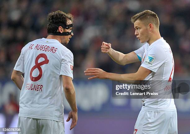 Alfred Finnbogason of FC Augsburg talks to his teammate Markus Feulner during the Bundesliga match between FC Augsburg and 1. FC Koeln at WWK Arena...