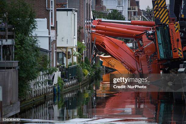 Aug. 6, 2015 - Two large cranes carrying a part of a bridge weighing 190 tons slid of a pontoon and crashed into several houses along the canal. The...