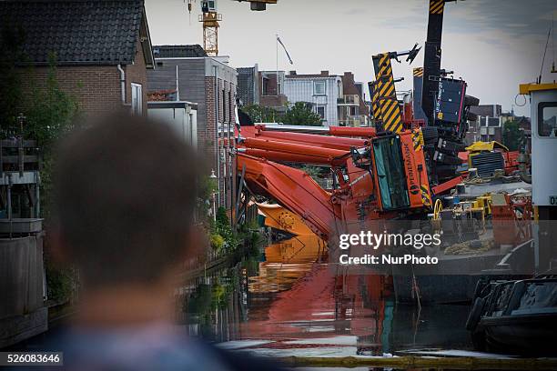 Aug. 6, 2015 - Two large cranes carrying a part of a bridge weighing 190 tons slid of a pontoon and crashed into several houses along the canal. The...