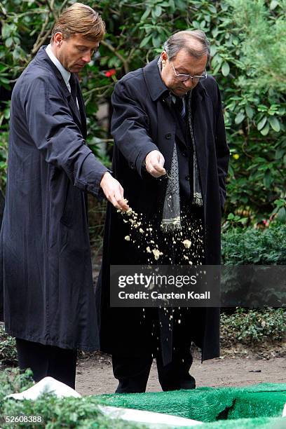 Actors Hagen Henning and Jaecki Schwarz stand in front of the grave at the furneral of late German actor Harald Juhnke in Waldfriedhof Dahlem...