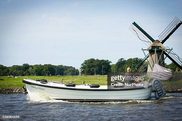 Blue heron is seen breathing excessively trying to comfort himself from the heavy moist air. People are seen enjoying the increasingly warm weather...