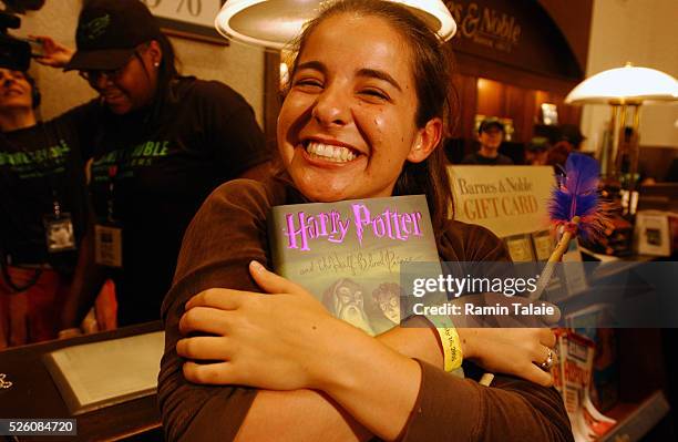 Rachel Grandi, 20 years old from Brooklyn celebrates after purchasing the very first Harry Potter book after midnight at a Barnes & Nobles bookseller...