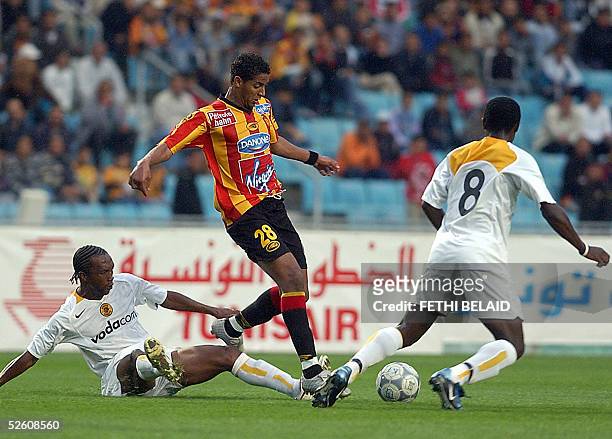 Tunisian Esperance striker Issam Jomaa vies with South Africa defender John Moshoeu and Washington Timashe during their African Champions League...