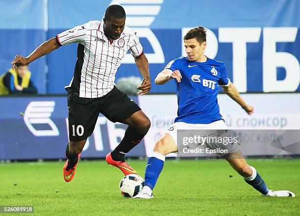 Igor Denisov of FC Dinamo Moscow and Bright Dike of FC Amkar Perm vie for the ball during the Russian Football League match between FC Dinamo Moscow...