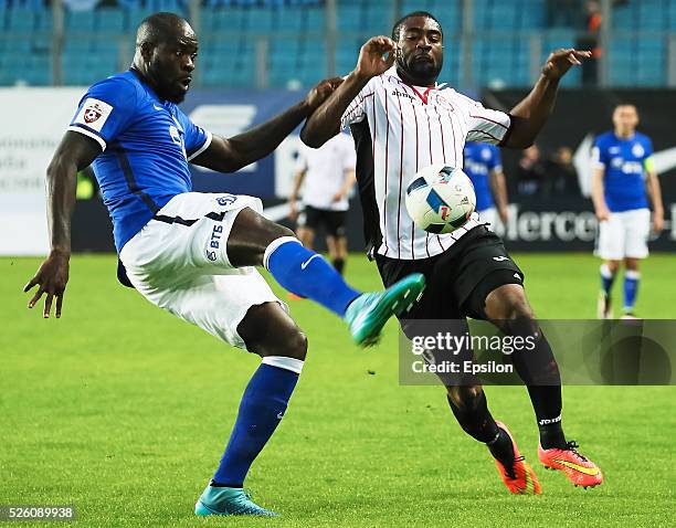 Christopher Samba of FC Dinamo Moscow and Bright Dike of FC Amkar Perm vie for the ball during the Russian Football League match between FC Dinamo...