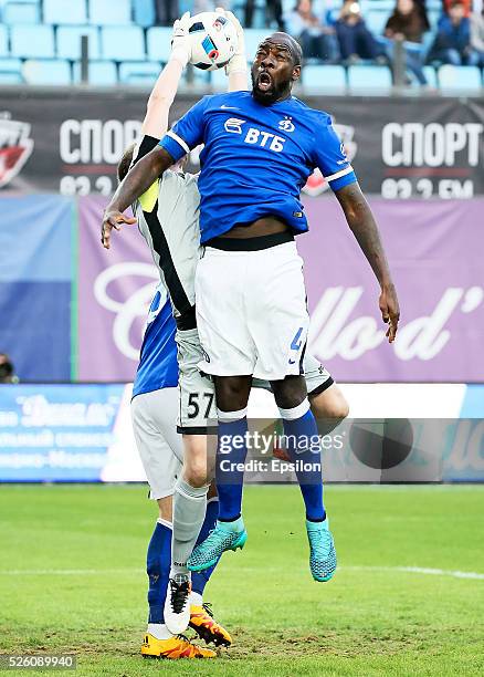 Christopher Samba of FC Dinamo Moscow and goalkeeper Aleksandr Selikhov of FC Amkar Perm vie for the ball during the Russian Football League match...