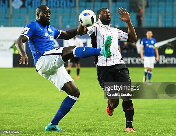 Christopher Samba of FC Dinamo Moscow and Bright Dike of FC Amkar Perm vie for the ball during the Russian Football League match between FC Dinamo...