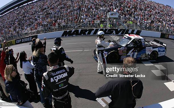 Bobby Labonte, driver of the Rodeway Inn/Econo Lodge/Trick Pony Chevrolet, is met by his crew members as he pulls across the finish line after...