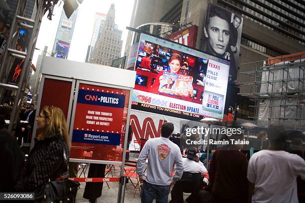 People watch a live broadcast of CNN during an election party in Times Square for the U.S. Presidential elections in New York City.