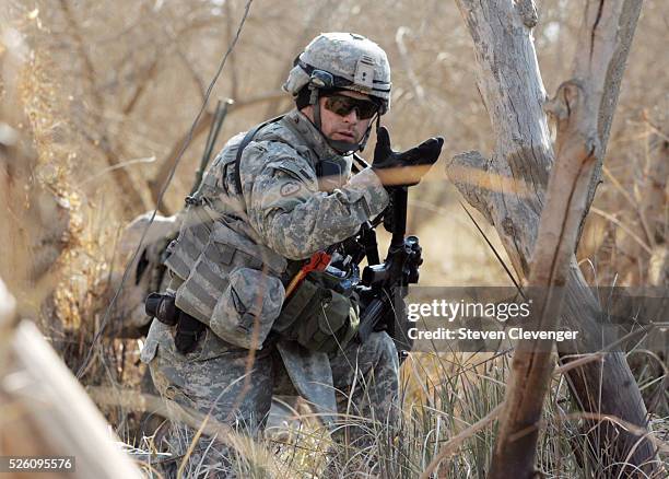 Member of H Company, 4th Brigade, 2nd Infantry motions fellow soldiers forward during their mission inside insurgent haven of Diyala, Iraq. The unit...