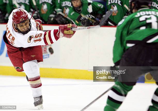 Forward Jon Foster of the Denver Pioneers shoots the puck against the North Dakota Fighting Sioux during the NCAA Frozen Four Championship game on...