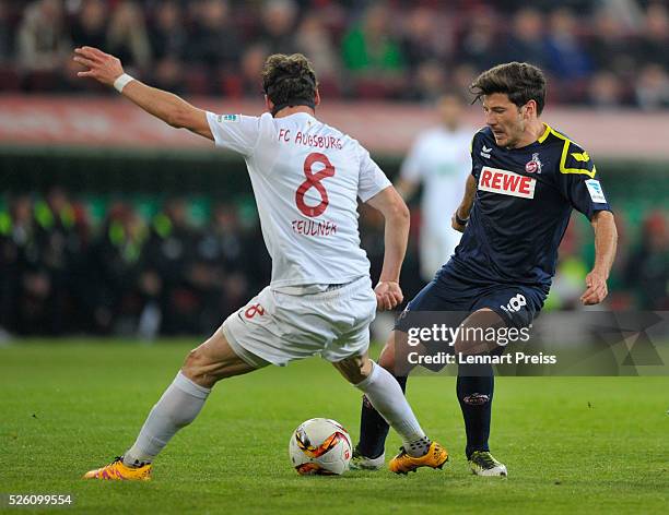 Markus Feulner of FC Augsburg challenges Milos Jojic of 1. FC Koeln during the Bundesliga match between FC Augsburg and 1. FC Koeln at WWK Arena on...