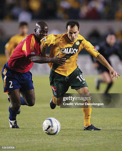 Landon Donovan of the Los Angeles Galaxy fights through the challenge of Nelson Akwari of Real Salt Lake during the first half of their major league...