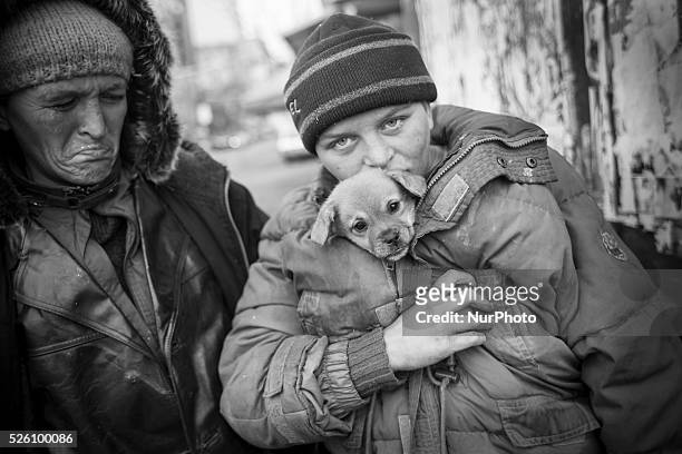 Maddalena Ilie with her dog and her mother, 38 year-old Flori Ilie. Both are homeless and addicted to huffing Aurolac paint. They survive by begging...