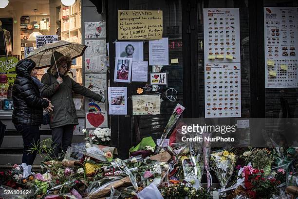 People look at the memorial in &quot;La Belle Equipe&quot; restaurant and a Japanese restaurant in the 11th district of Paris, on November 21, 2015...