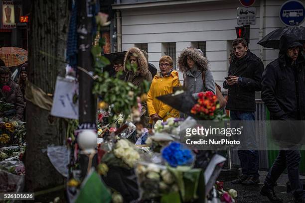 People look at the memorial in &quot;La Belle Equipe&quot; restaurant in the 11th district of Paris, on November 21, 2015 following a series of...