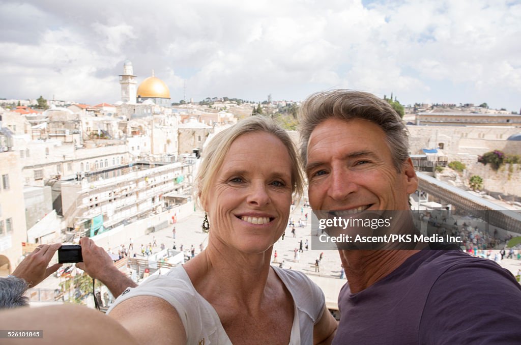 Couple take selfie portrait above Western Wall