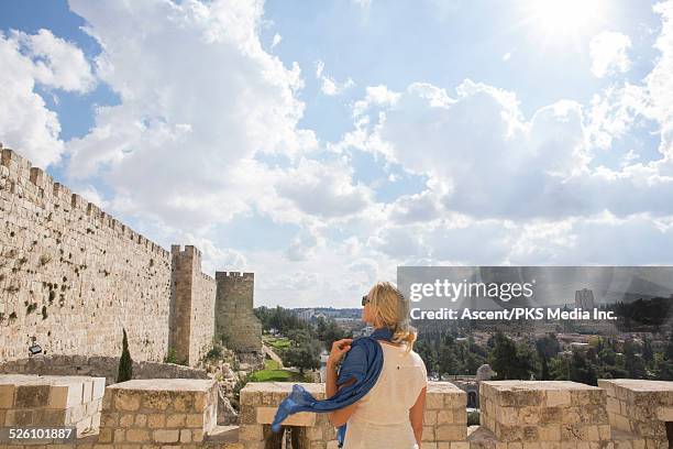 female traveller looks at city wall, jaffa gate - israeli woman imagens e fotografias de stock