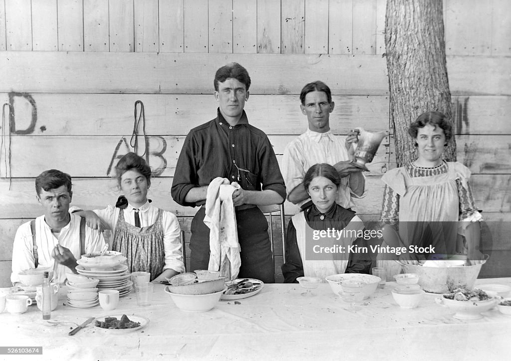 Dishes are cleared after a dinner party, ca. 1905