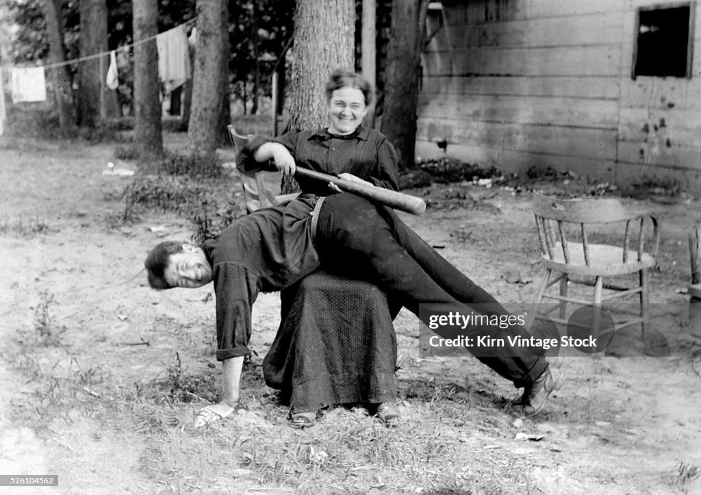 Woman spanks man with baseball bat playfully, ca. 1905 News Photo - Getty  Images