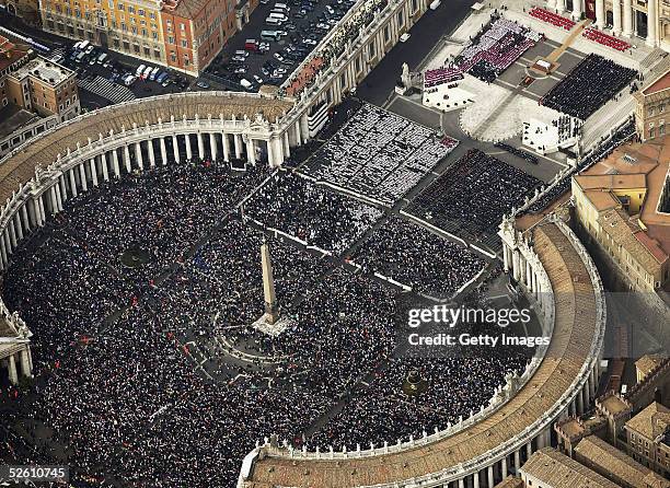 In this handout aerial photo provided by the Italian State Police , thousands of gathered pilgrims attend the funeral of Pope John Paul II in St....