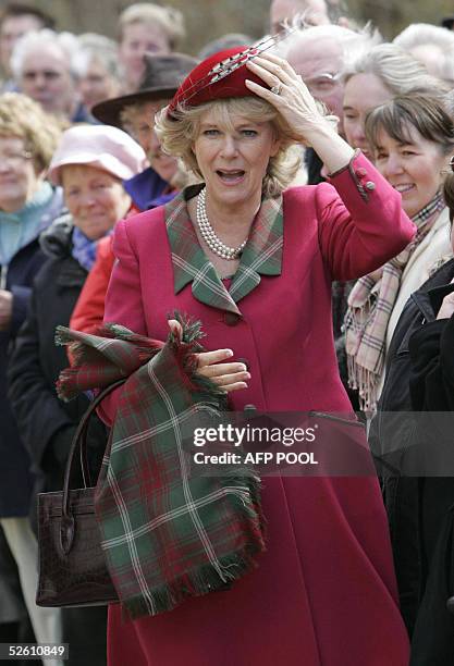 The Duchess of Cornwall holds on to her hat outside Crathie Parish Church in Aberdeenshire 10 April 2005 in her first public engagement since...