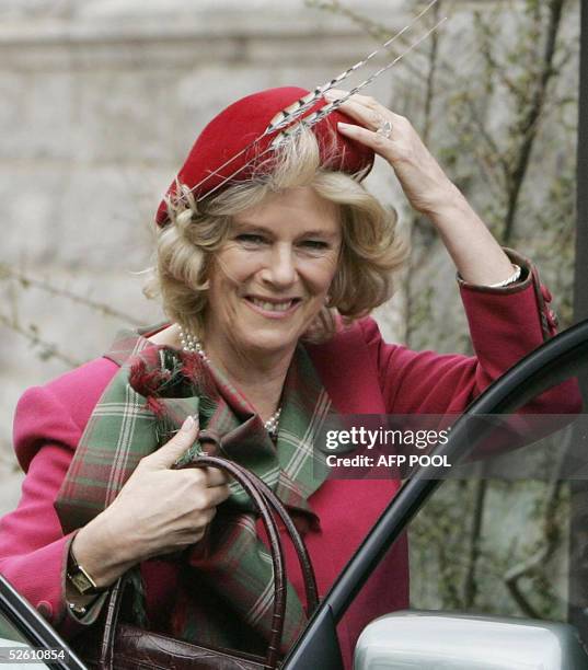 The Duchess of Cornwall holds on to her hat outside Crathie Parish Church in Aberdeenshire 10 April 2005 in her first public engagement since...