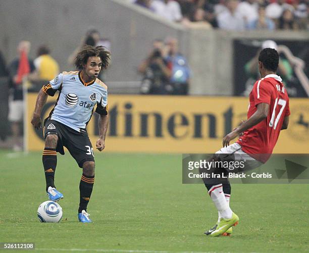 All Star player Kevin Alton of New England Revolution eyes the break against Manchester United's Nani during the MLS All Star Game game between the...