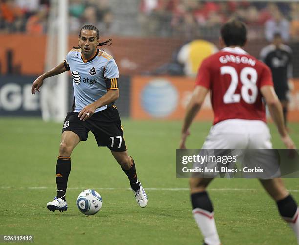 All Star player Dwayne De Rosario of Toronto FC moves the ball against Manchester United's Darron Gibson during the MLS All Star Game game between...